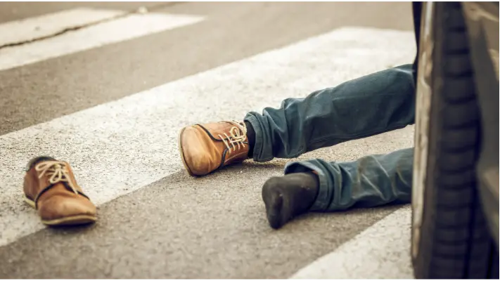 image of a pedestrian knocked to the floor in the moddle of a crosswalk