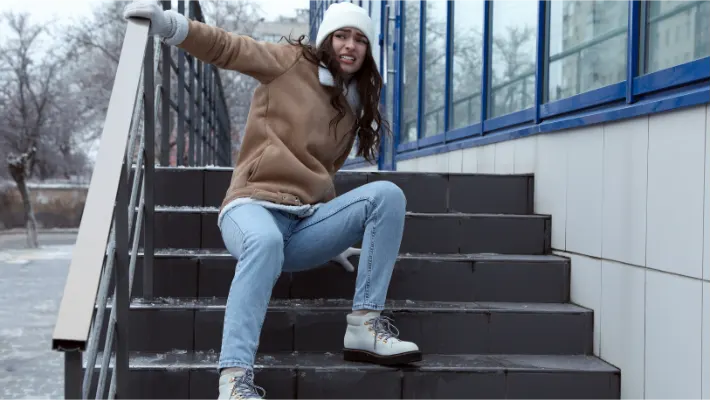 image of a person who fell ont the floor with a skippery when wet sign in frame